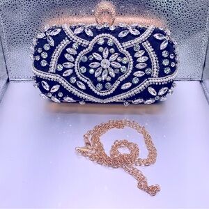 Black clutch decorated with clear rhinestones